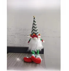 Detailed view of plush Christmas gnome with green herringbone hat and golden bell