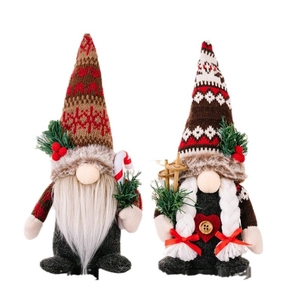 Christmas Gnome dolls with knitted hats holding ski boards and candy canes for holiday decor