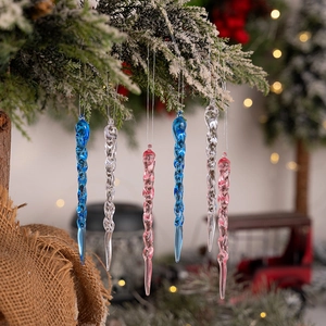 Pink and blue acrylic spiral icicle ornaments hanging on a snowy Christmas tree