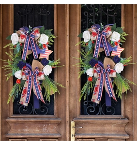 Patriotic door wreaths with blue and white roses, US flag ribbons, and wooden stars