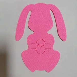 Pink felt bunny-shaped cutlery holder with laser-cut details for Easter table decor