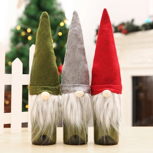 Three festive Christmas gnome wine bottle covers in green, grey, and red felt material