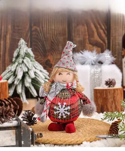 Detail of Christmas gnome plush with red-green plaid body and grey knitted heart hat