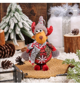 Detail of a Christmas reindeer plush with plaid fabric and snowflake embroidery on a snowy rug