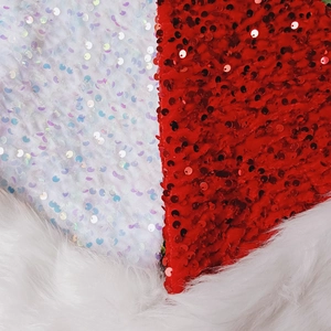Detail of red and white reversible sequins and soft faux fur trim on Christmas hat