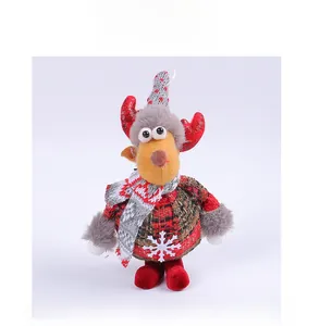 Detail of reindeer plush ornament with red plaid jacket and knitted scarf for Christmas