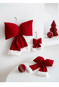Close-up of red velvet Christmas bow ornaments with white faux fur trim in various sizes