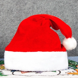 Classic red plush Santa Claus hat with soft white faux fur trim and fluffy pompom ornament