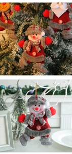 Detailed view of Christmas fabric ornaments with snowflake buttons and golden hanging ropes