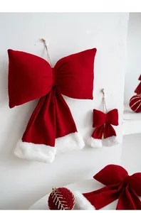 Detail of red velvet Christmas bow with white plush trim for festive tree decoration