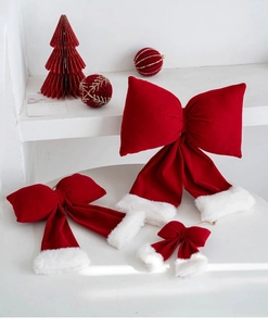 Detailed view of red velvet Christmas bow ornaments with soft white plush trim