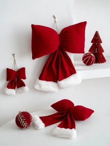 Detail of red velvet Christmas bows with white faux fur trim for festive tree decoration