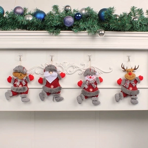 Set of 4 plush Christmas ornaments with Santa, Snowman, Bear and Deer on a white mantel