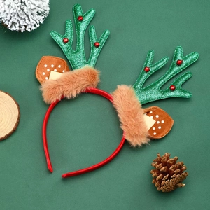 Close-up of Christmas antler headband with green sequins, red bells and furry ears
