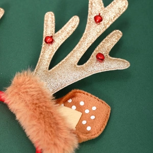 Detail of Christmas reindeer headband with gold sequins, red bells and plush polka dot ears