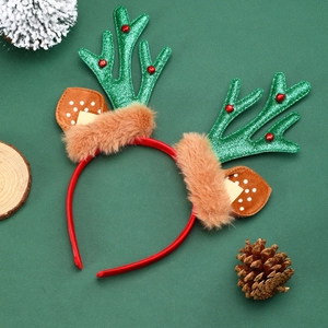 Christmas reindeer antler headband with green sequins and brown plush ears on a green background