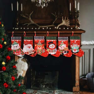 Set of 6 Christmas stockings with plaid trim and cartoon characters hanging on a fireplace