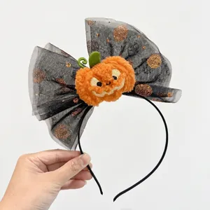 Halloween headband featuring a large black mesh bow with a velvet pumpkin center