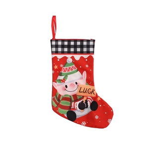 Christmas stocking with red base, plaid cuff and cartoon elf holding a LUCK sign