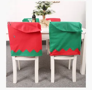 Detail of red and green Christmas elf chair cover with white plush pom-pom and felt fabric