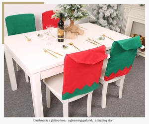 Detail of red and green non-woven elf chair covers with white pom-poms for Christmas decor