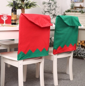 Christmas elf hat chair covers in red and green felt with pom-poms for festive dining decor