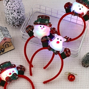 LED Christmas headband set with Santa, Reindeer, and Snowman on a white basket