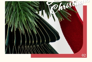 Macro shot of dark green pleated Christmas tree ornament with red velvet ribbon and gold edges
