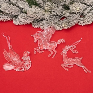 Three transparent acrylic Christmas ornaments featuring unicorn, deer, and bird shapes
