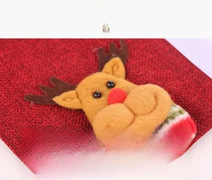 Close-up of burlap Christmas handle cover featuring a plush reindeer and velcro fastener