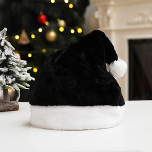 Close-up of a plush black Christmas hat with white faux fur trim and pompom decoration