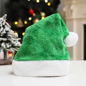 Detailed close-up of green plush Christmas hat with soft white faux fur trim and pompom