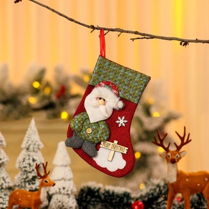 Linen Christmas stocking with Santa patch, plaid pattern, and Merry Christmas wood sign