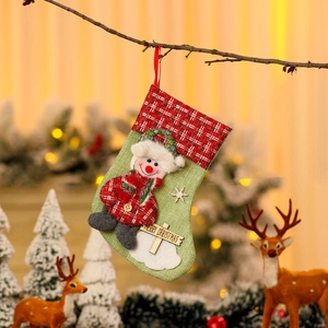 Linen Christmas stocking with snowman holding a wooden Merry Christmas sign on tree