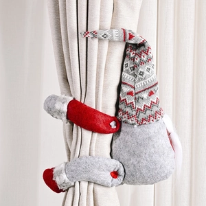 Christmas gnome curtain tieback with striped hat and white beard on window curtain