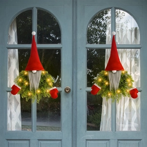 Luminous Christmas faceless gnome wreaths with LED lights on elegant grey doors