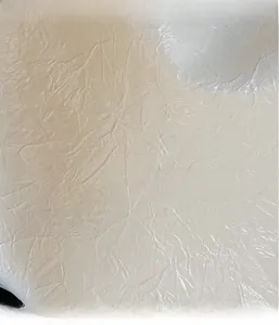 Macro shot of off-white pearlized fabric with natural crinkle texture for luxury tote bag
