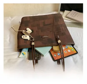 Detail view of the spacious inner compartment of the brown vintage tote bag with items