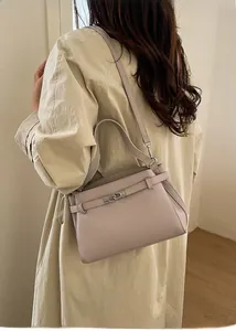 Detail of lavender leather handbag with lychee grain texture and metal twist lock detail