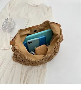 Top-down shot of a straw tote bag interior showing large capacity and magnetic closure