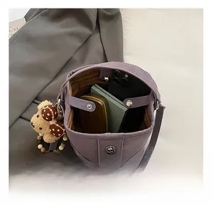 Top view of purple bucket bag interior showing large capacity for phone and wallet