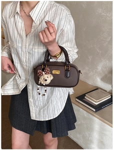 Deep brown Boston handbag with cute plush bear charm and beaded strap detail
