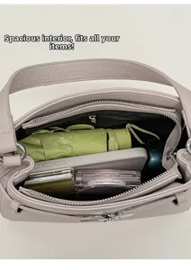 Spacious interior of purple pebble leather bag showing capacity for phone and umbrella