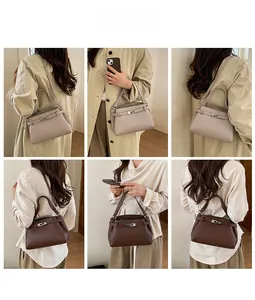 Detailed view of the textured leather texture and metal buckle on the crossbody bag