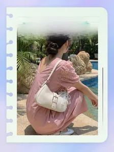 White glossy faux leather underarm bag with silver buckle and pearl lace charm
