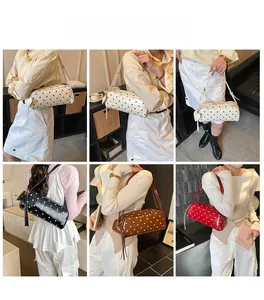 Detailed view of polka dot cylindrical shoulder bag in various colors worn by a model