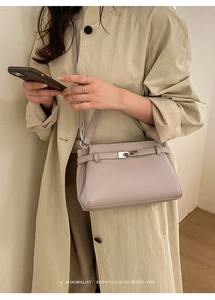Chic lilac pebble leather crossbody bag styled with a minimalist khaki trench coat