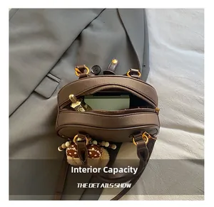 Top view showing the internal capacity of a brown leather pillow bag with gold hardware