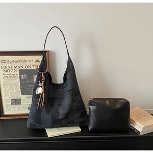 Detail view of canvas tote bag with geometric pattern and matching black zipper pouch