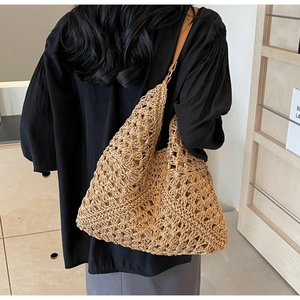 Detail of hollow woven beach tote with brown leather strap and large capacity texture